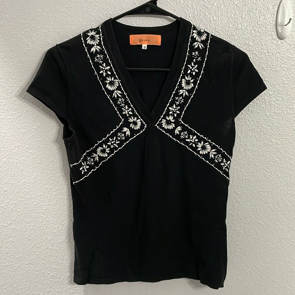 Black shirt with white design.